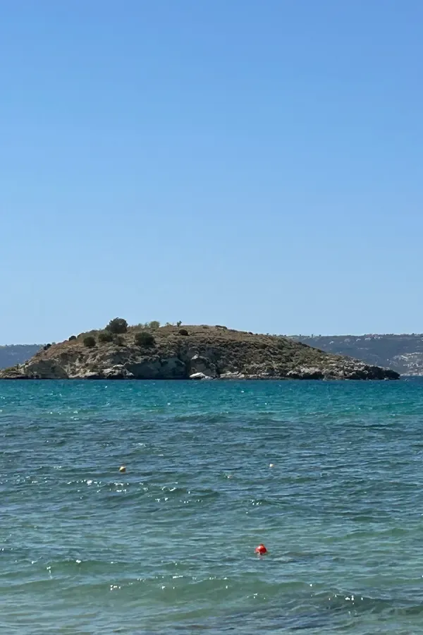 White-washed buildings and the clear blue sea view in Almyrida village, Crete.