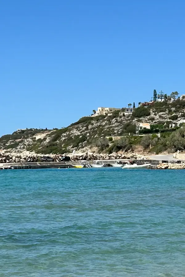 Bright blue Aegean Sea meeting the rocky coastline near Almyrida, Crete.