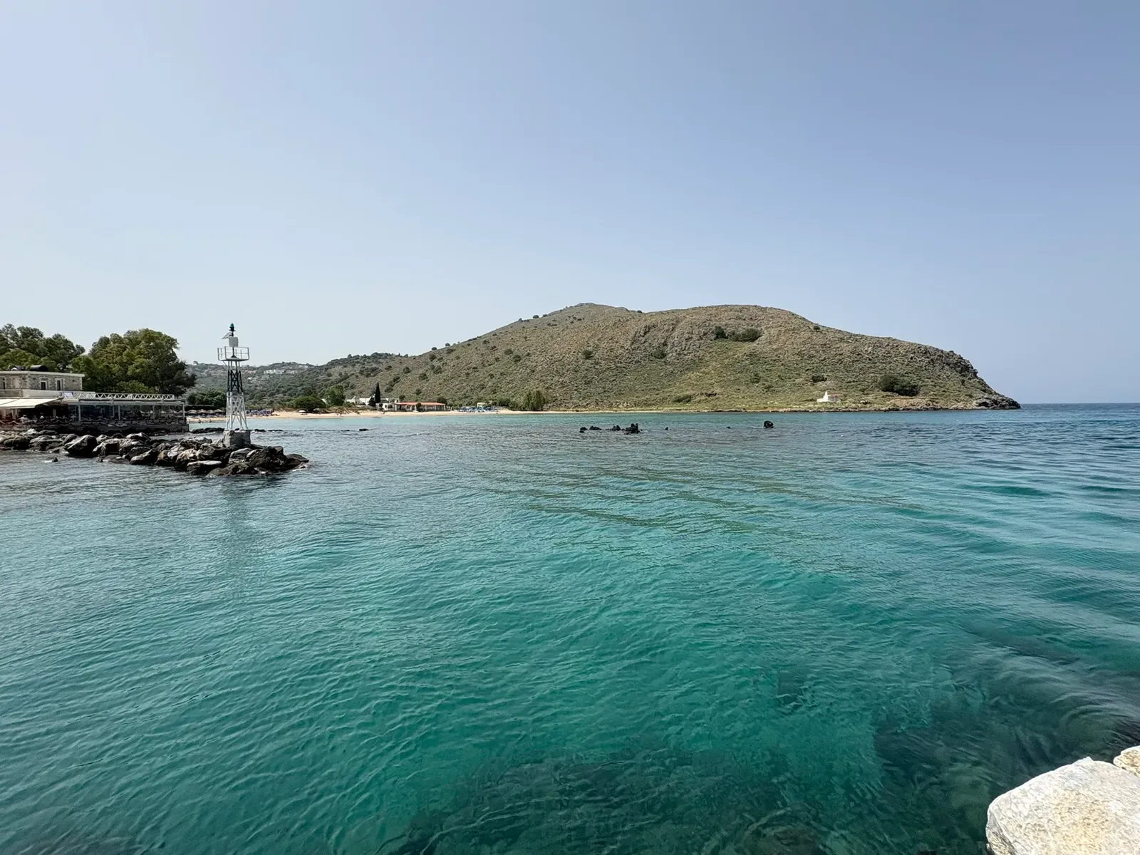 The coastline of Georgioupoli, featuring golden sand beaches meeting the deep blue Aegean Sea.