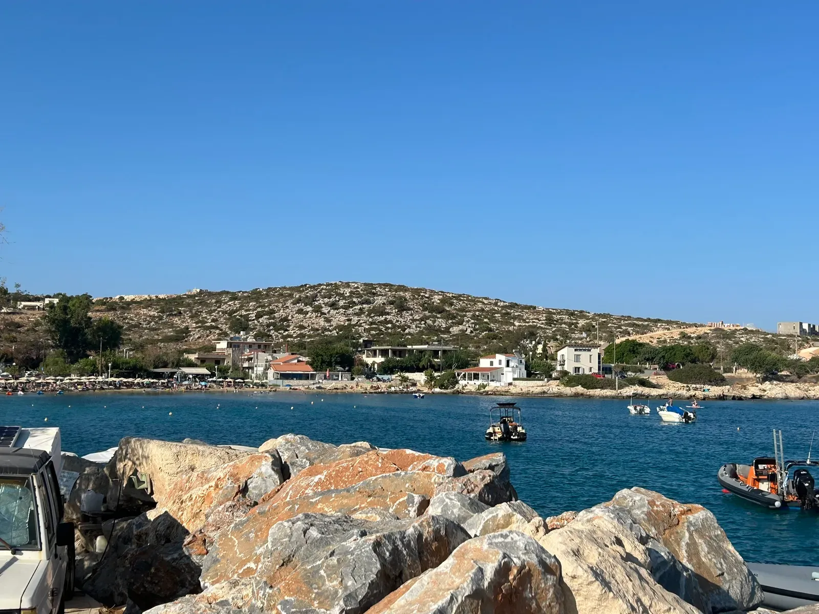 The coastal landscape and village life at Marathi, Crete, viewed from the sea.