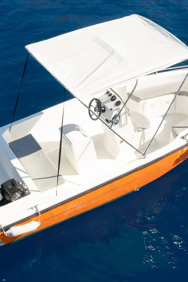 Deep blue waters and the coastline of Notos Mare, showing boat passage near Crete.