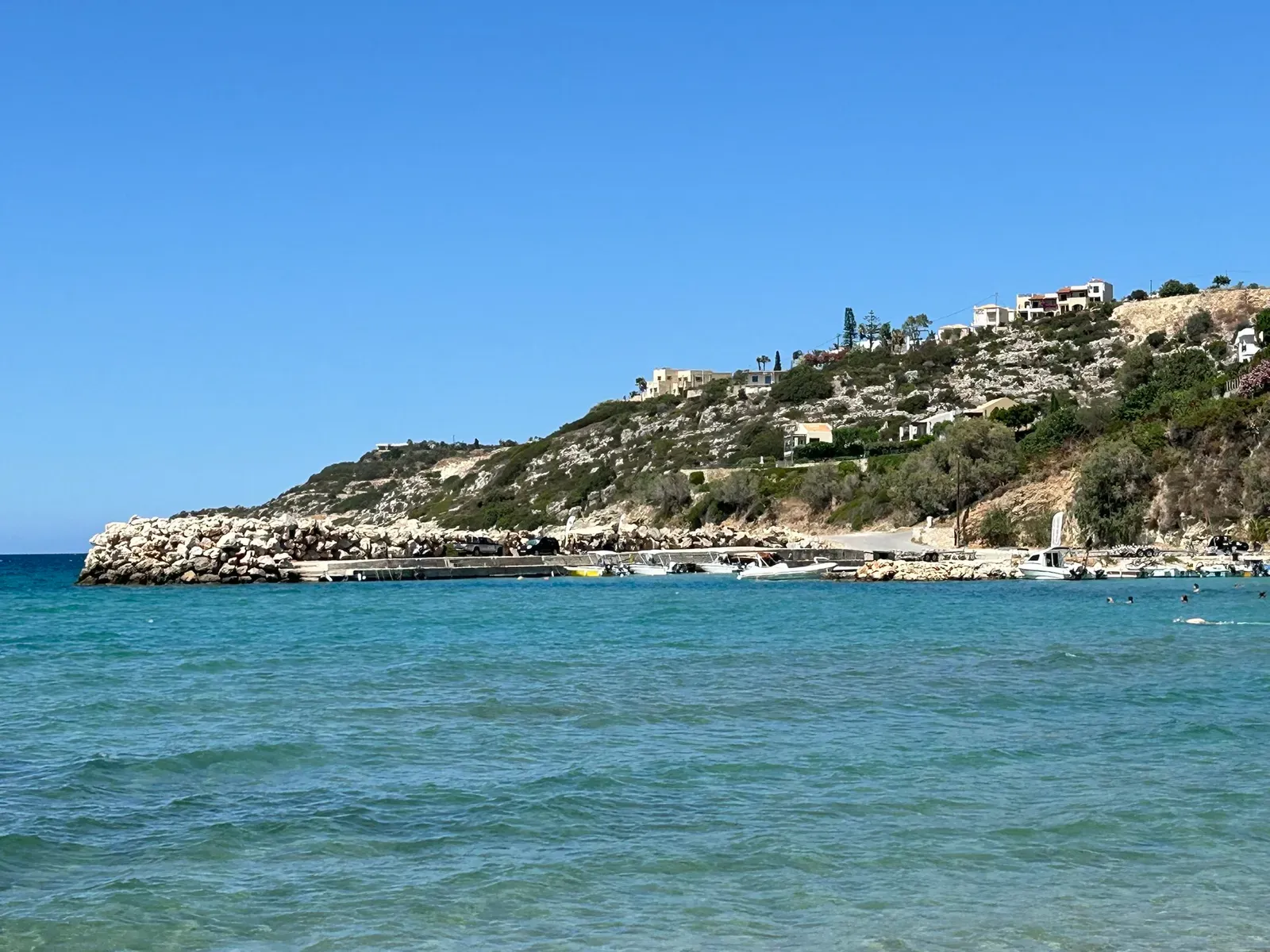 Bright blue Aegean Sea meeting the rocky coastline near Almyrida, Crete.