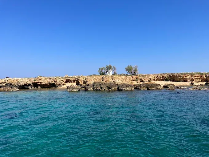 Golden sands and crystal-clear turquoise waters mark the picturesque stretch of Lazareta beach on Crete.