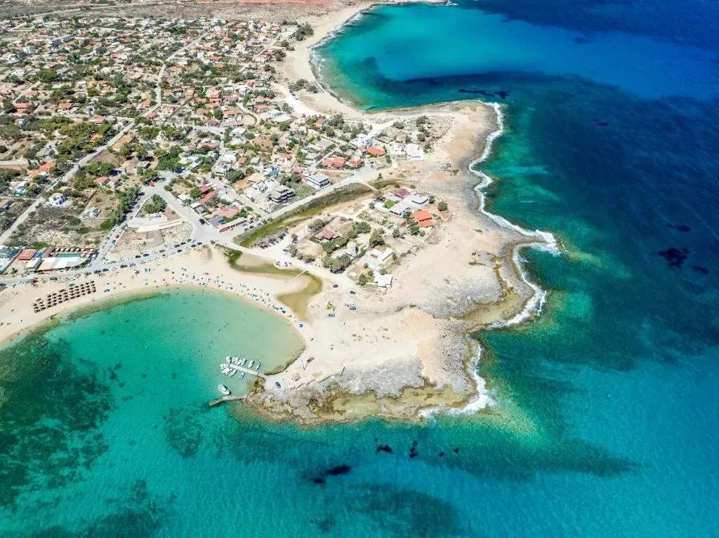 Clear turquoise waters meeting the rugged shoreline near Stavros, a beautiful destination in Crete.